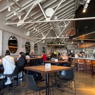 people sitting at tables in a restaurant