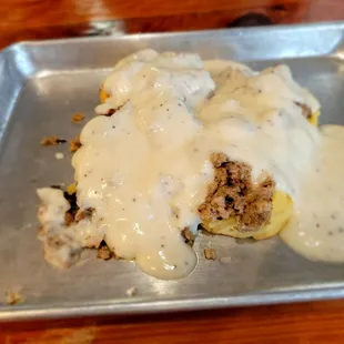 Biscuits with barely warm sausage gravy.