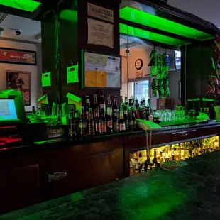 a bar with green lights
