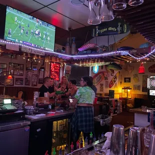 a bar with people watching a football game