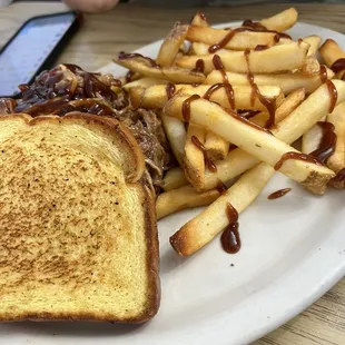 Pulled pork on garlic bread with barbecue decorated french fries
