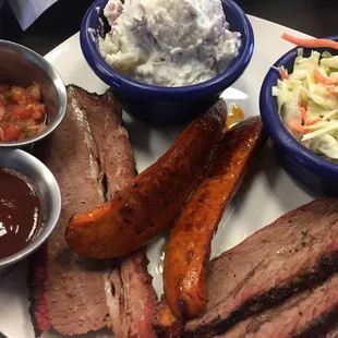 Three meat plate with brisket, hot link and tri tip and potato salad and cole slaw