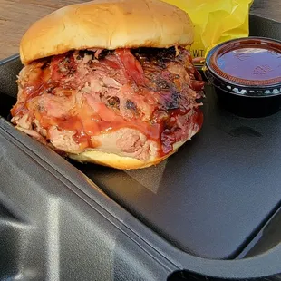 Juicy Pulled Pork sandwich on a soft bun, extra BBQ sauce.