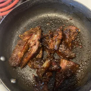 a frying pan filled with meat