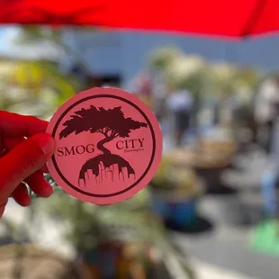 a hand holding a sticker