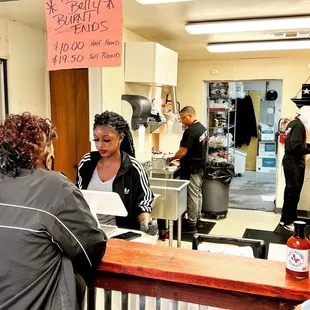 ows a woman at the counter