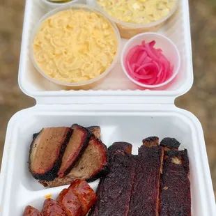 a tray of meat and sides