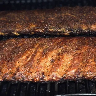 two ribs cooking on a grill