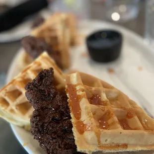 a plate of waffles with syrup