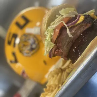 a hamburger and fries on a tray