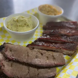 a plate of meat and side dishes