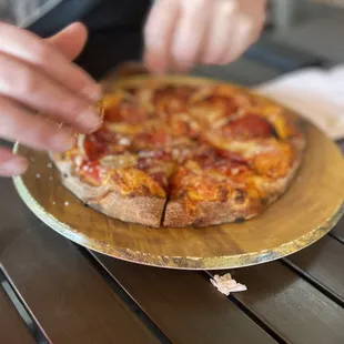 a person cutting a pizza