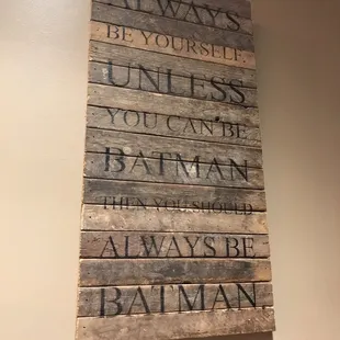 a wooden sign that says always be yourself unless you can be batman