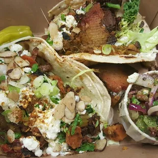 a variety of tacos in a box