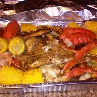 Smoked Seafood Boil-Lobster Tails, Crab Legs, Shrimp, Andouille Sausage, Corn, Potatoes, your choice of Smoked Catfish, Smoked Salmon
