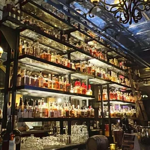 a bar with many bottles of alcohol