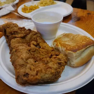 a plate of fried chicken with a side of macaroni and cheese