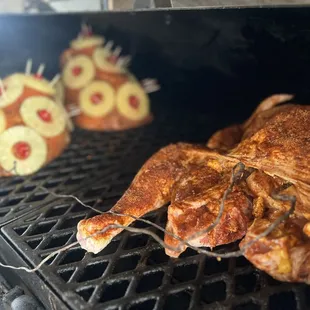 a roasting chicken on a grill