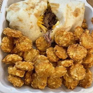 Brisket breakfast burrito ($13) and pork rubbed potato rounds ($7)