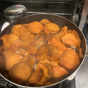 a pan of food cooking on a stove