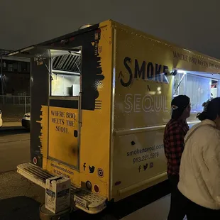 a yellow food truck at night