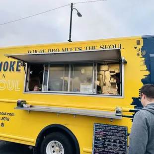 a man standing in front of a food truck