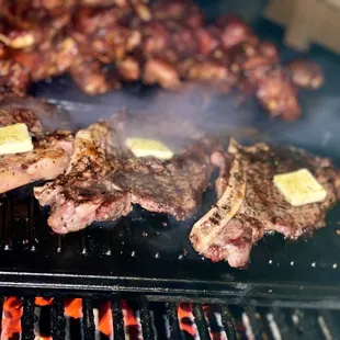 steaks cooking on the grill