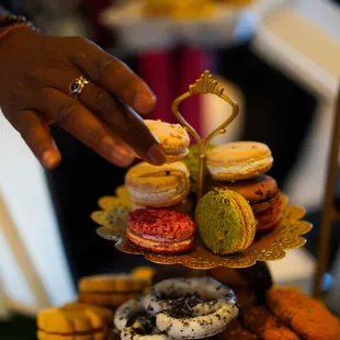 a hand reaching for a dessert