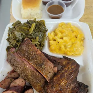 a plate of meat, macaroni, and cheese