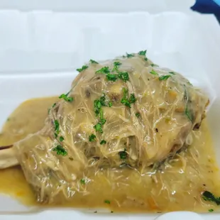 a piece of meat covered in sauce