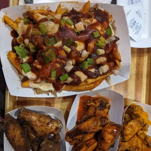 BBQ pork fries. Left to right wings: Jamaican dry rub, hot buffalo, and spicy garlic.