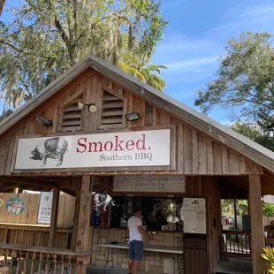 a man standing in front of a restaurant