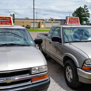 two pickup trucks parked in a parking lot