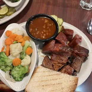 Burnt brisket ends, sausage, steamed veggies, and bbq beans.  Delicious!