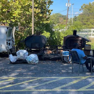 a man sitting in a chair in a parking lot