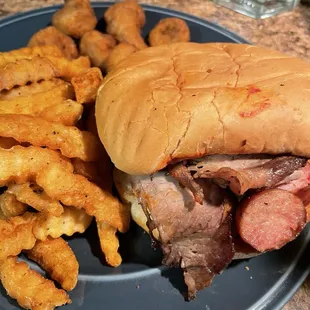 Large sandwich with beef and sausage  French fries Mushrooms