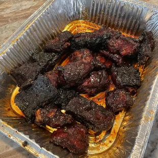 barbecued meat in a foil pan