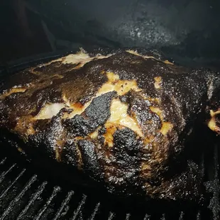 a piece of meat cooking on a grill