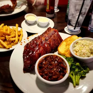 European style 1/2 rack of baby back ribs w/ coleslaw, broccoli, and baked beans also a piece of texas toast