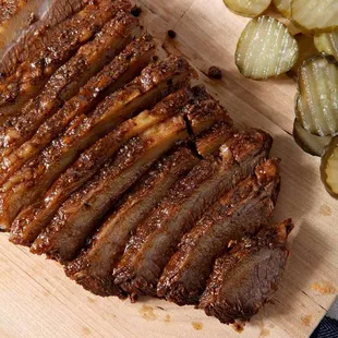 a sliced brisked pork on a cutting board