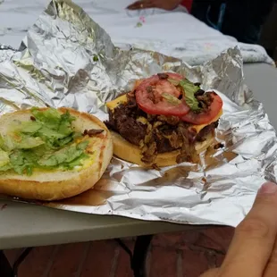 a hand holding a sandwich