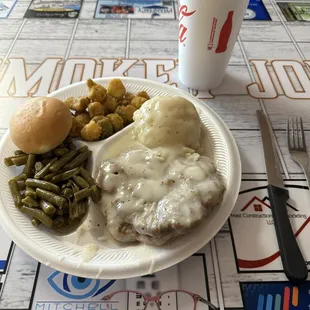 Country fried steak, okra,green beans and mashed potatoes with a roll