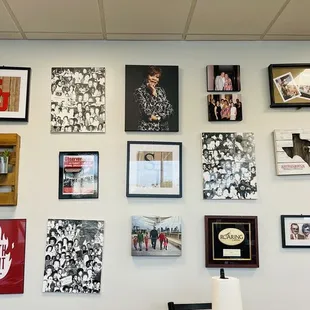 ows a wall of framed photographs