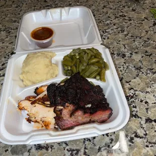 ows meat and sides in a styrofoam container