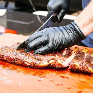 a person cutting a piece of meat