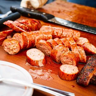 a cutting board with a variety of meats