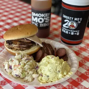 Sliced Pork Loin sandwich, sliced jalapeño sausage, coleslaw and potato salad.