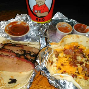 Breakfast tacos: Left: Brisket and Mo sauce Right: Bacon, egg and cheese  Salsa and vinegar-pepper sauce