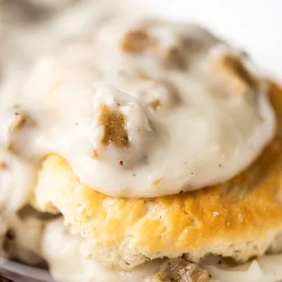 a closeup of a sausage and gravy sandwich