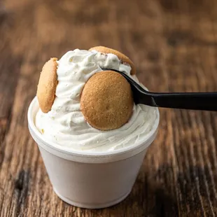 a cup of ice cream with a cookie on top